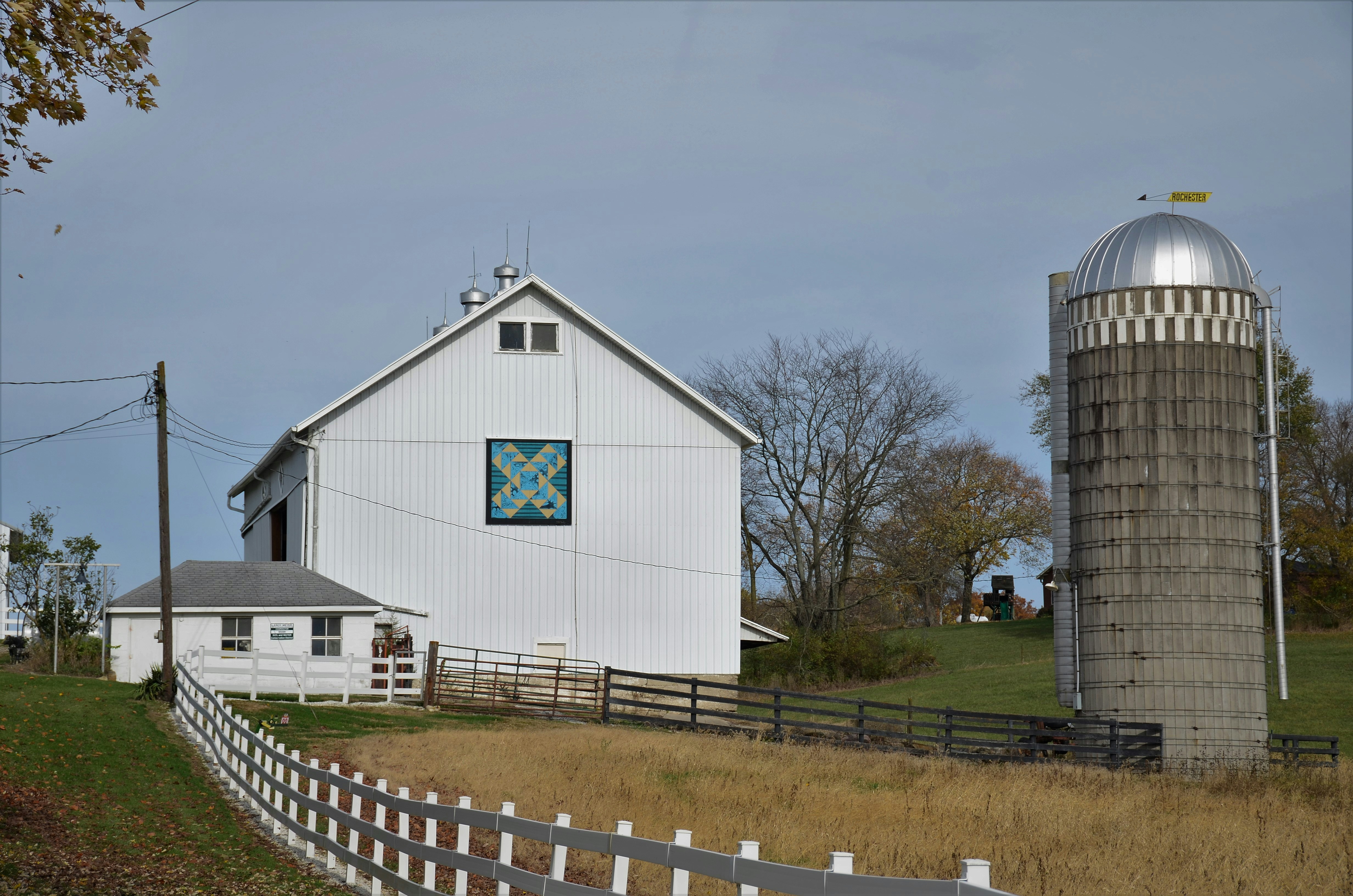 White barn and shed with barn quilt